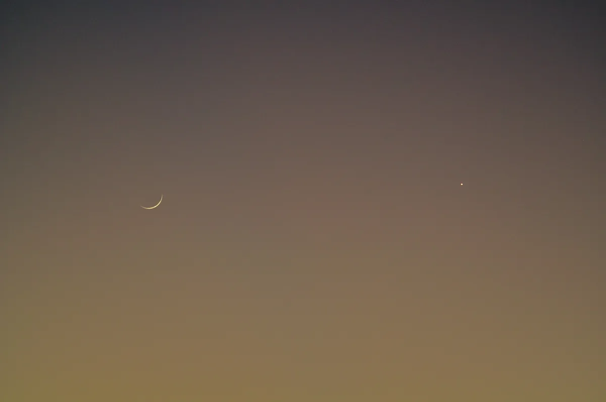 New moon and Venus seen in the sky together near sunset