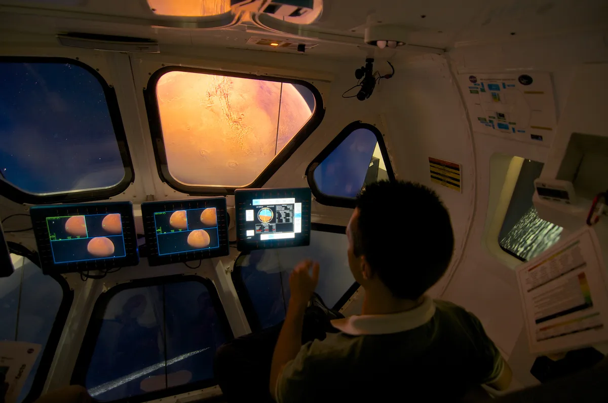 Simulation of commanding a spacecraft on the moon of Phobos with Mars out the viewport