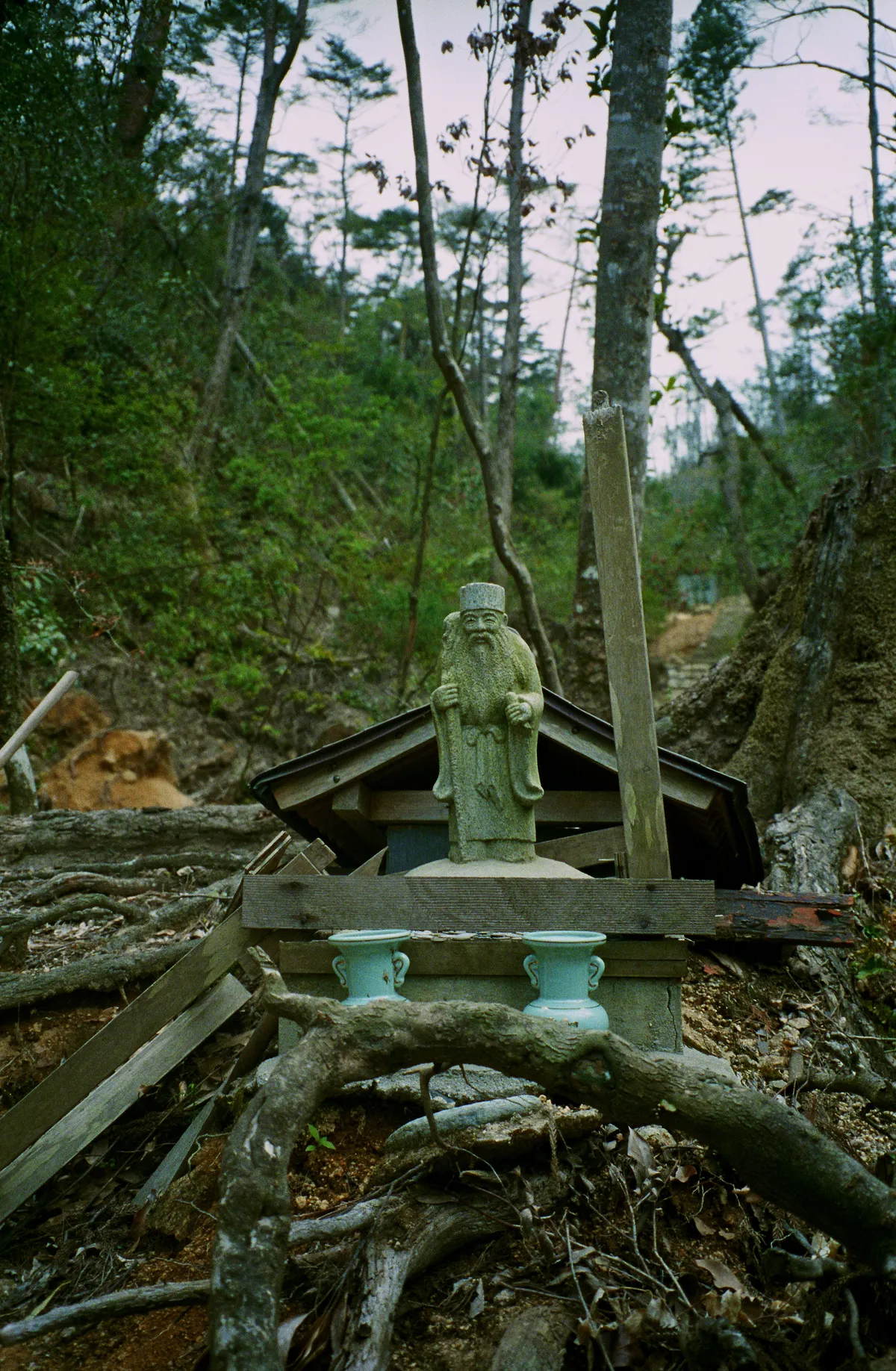 Small shrine in the hills near to Hiroshima where a recent typhoon had taken down a few other buildings and trees