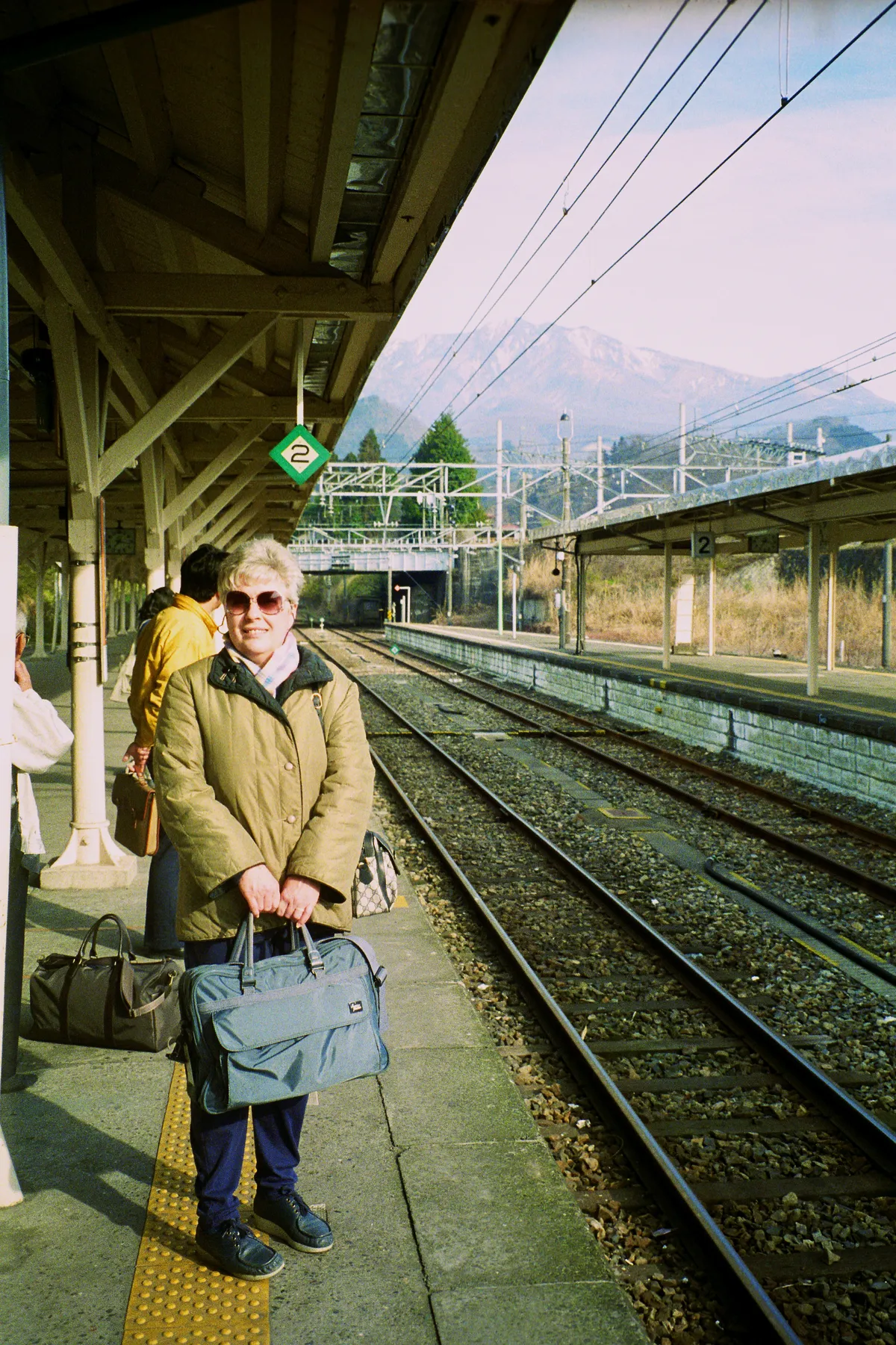 My mother patiently waiting for a train bound for somewhere