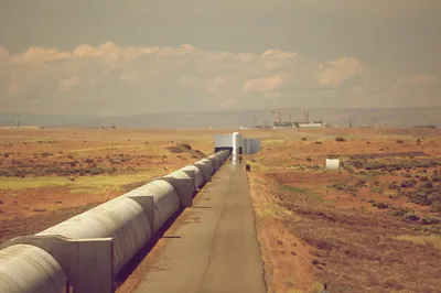 Four kilometers of covered vacuum'ed pipes with the Hanford waste facility cranes in the distance
